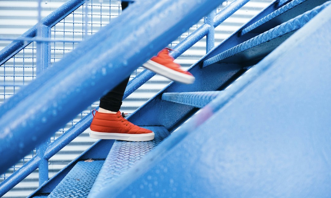 person stepping on blue stairs