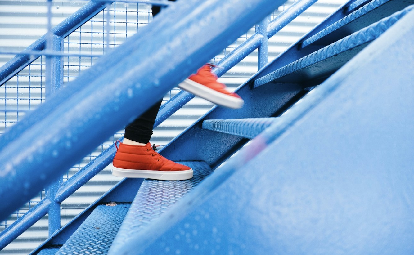 person stepping on blue stairs